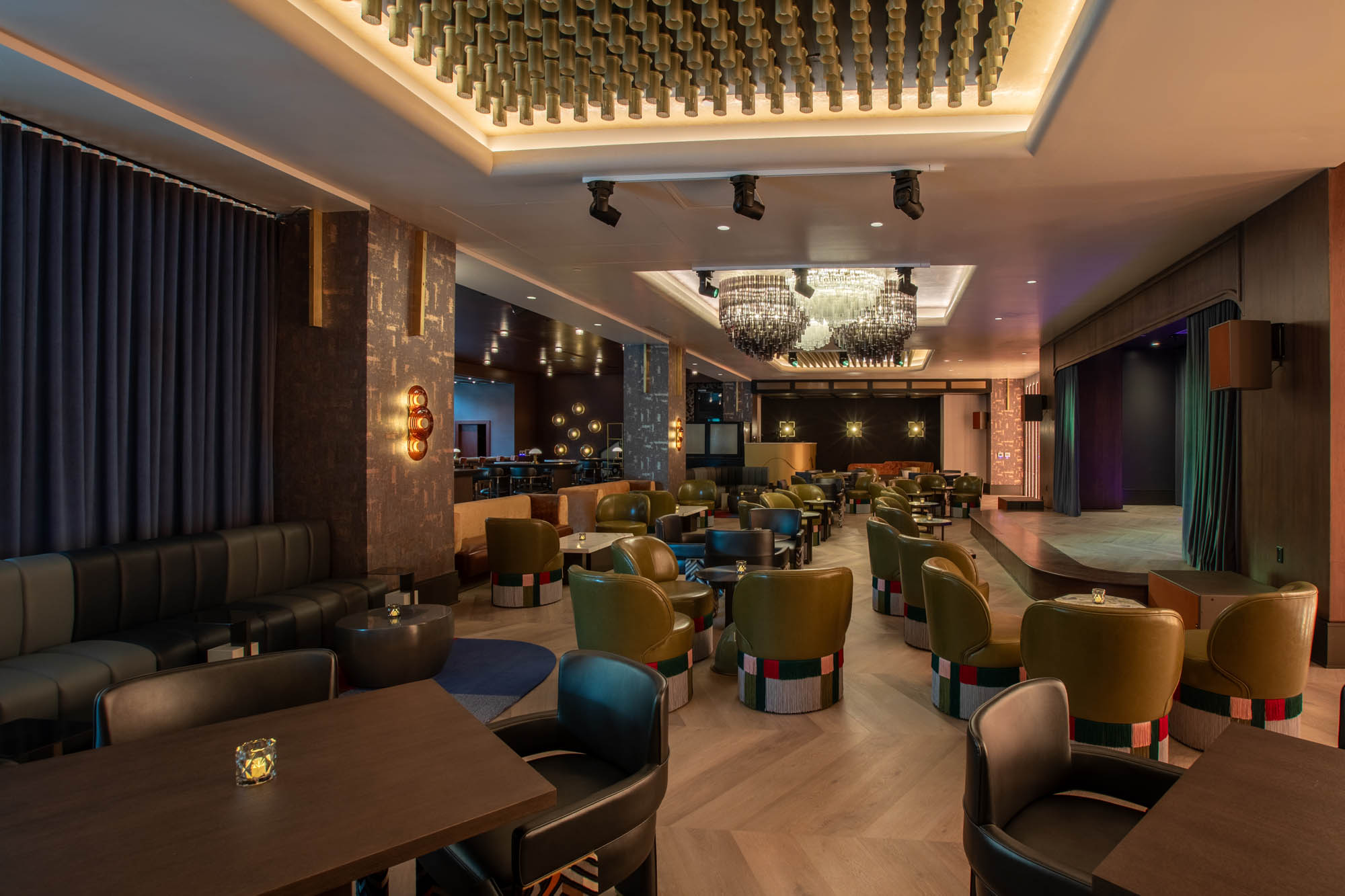 View of the interior of Seratonic with low tables and a stage off to the right side.